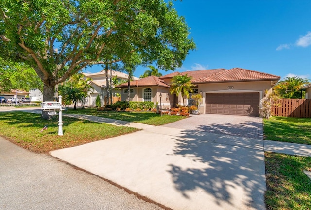 view of front of house featuring a garage and a front lawn