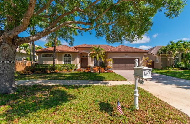 mediterranean / spanish-style house featuring a front lawn and a garage