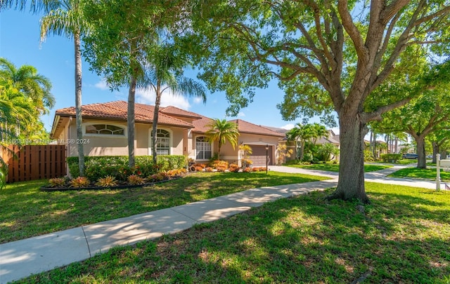 view of front of house featuring a garage and a front lawn