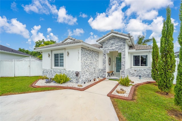 mediterranean / spanish-style home featuring a front lawn