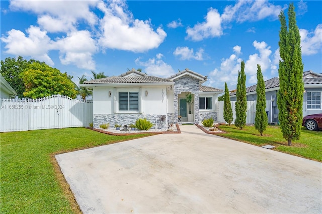 mediterranean / spanish home with a front lawn