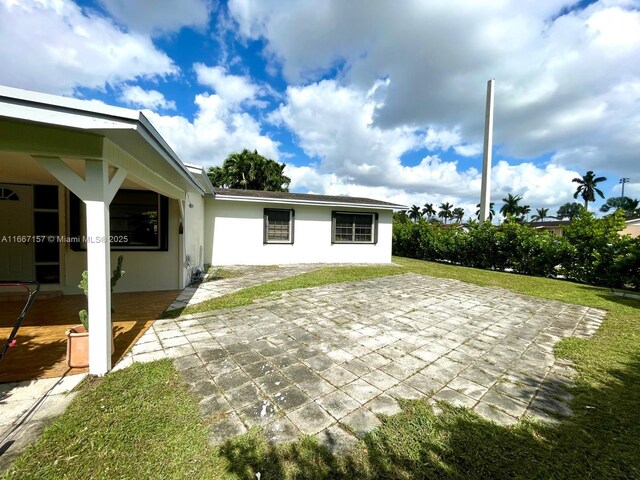 exterior space with area for grilling, a garage, and an outbuilding