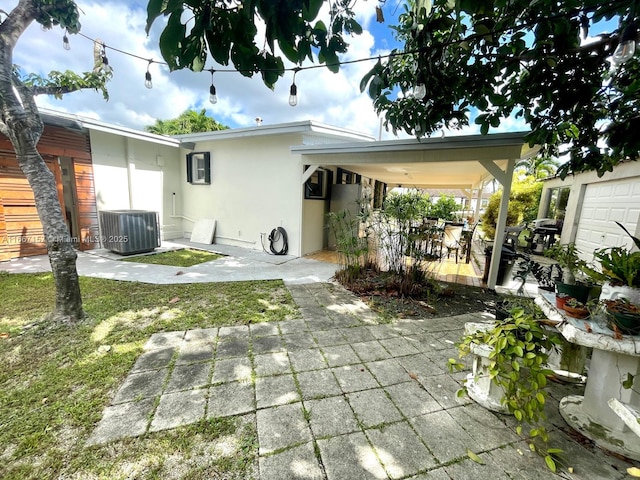 rear view of house featuring central AC