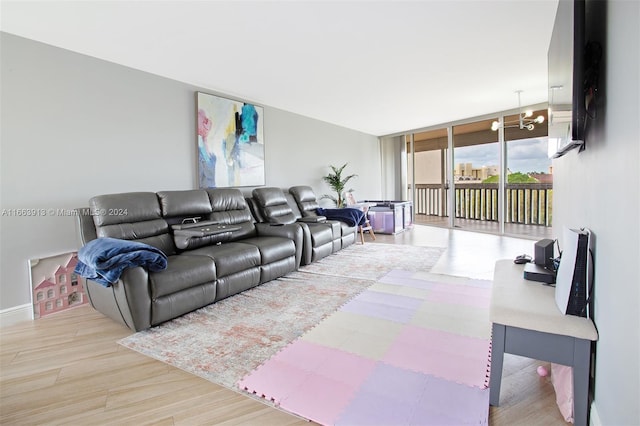 living room featuring a wall of windows and light wood-type flooring