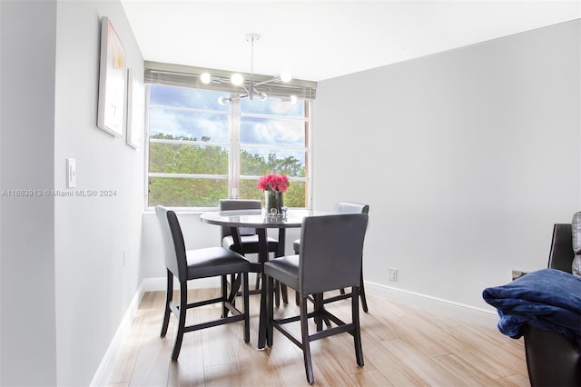 dining space with an inviting chandelier and light wood-type flooring