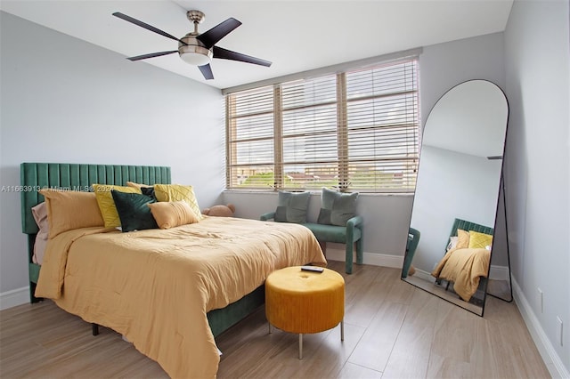 bedroom with light wood-type flooring and ceiling fan