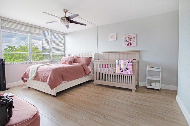 bedroom featuring ceiling fan and light hardwood / wood-style flooring