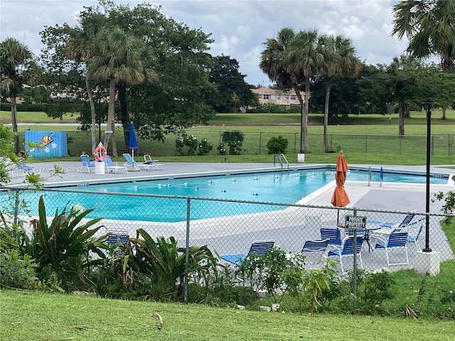 view of pool featuring a yard and a patio area