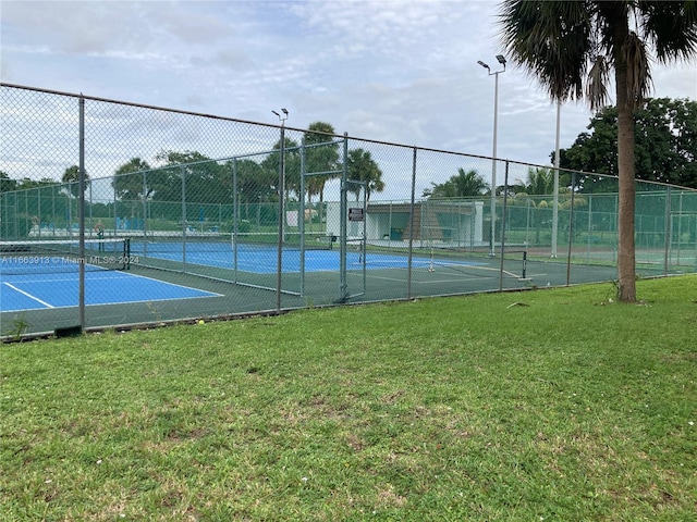 view of sport court featuring a yard