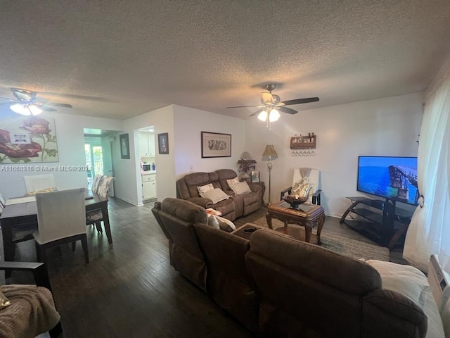 living room featuring ceiling fan, a textured ceiling, and dark hardwood / wood-style flooring