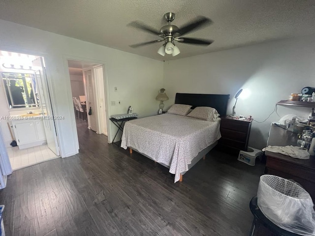 bedroom with a ceiling fan, wood finished floors, a textured ceiling, and connected bathroom