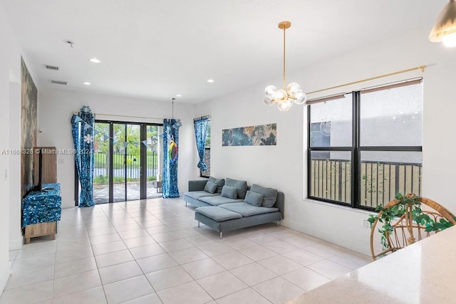 tiled living room featuring a notable chandelier