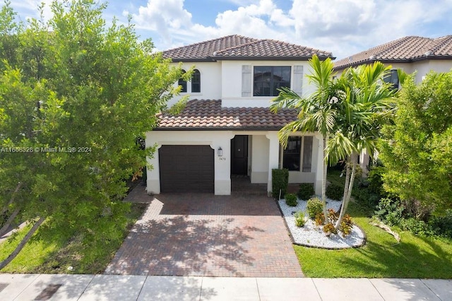 mediterranean / spanish-style home with a garage