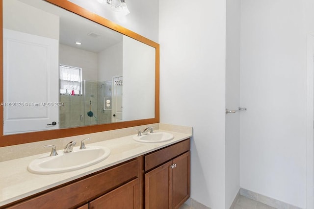 bathroom with tile patterned flooring, walk in shower, and vanity