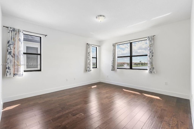 empty room with dark wood-type flooring