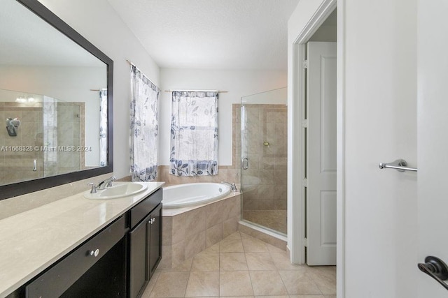 bathroom featuring independent shower and bath, vanity, and tile patterned flooring