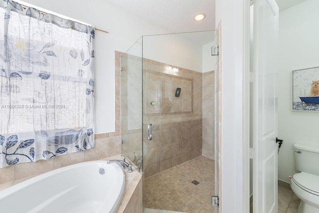 bathroom featuring tile patterned flooring, separate shower and tub, and toilet