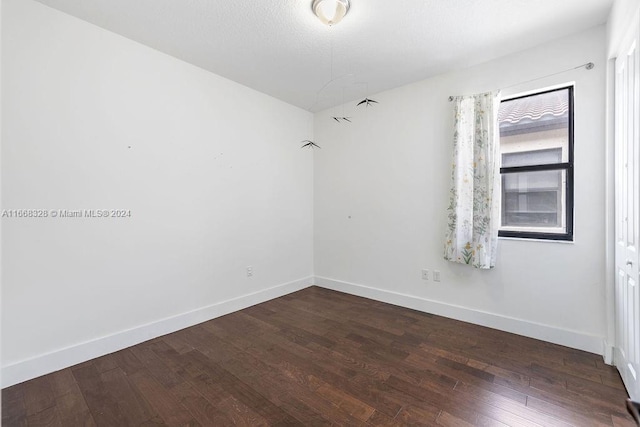 unfurnished room featuring dark hardwood / wood-style floors