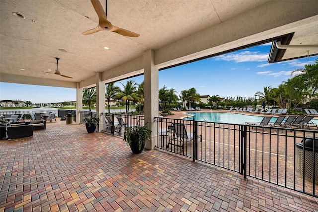 view of patio featuring ceiling fan and a community pool