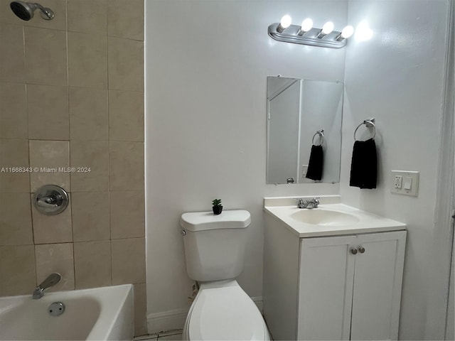 full bathroom featuring tiled shower / bath combo, vanity, and toilet