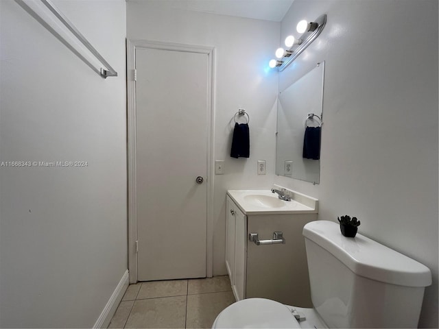 bathroom featuring tile patterned flooring, vanity, and toilet