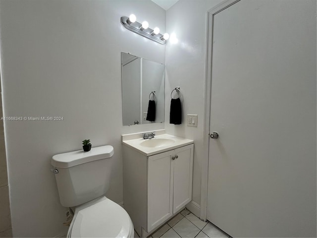 bathroom with vanity, toilet, and tile patterned floors