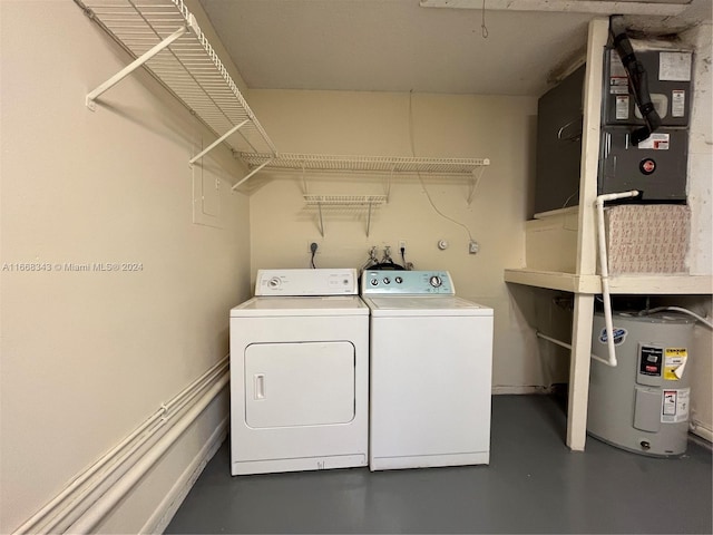 clothes washing area featuring electric water heater, heating unit, and washer and dryer