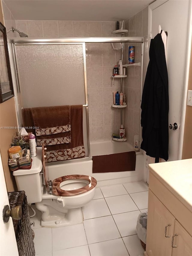 full bathroom with bath / shower combo with glass door, vanity, toilet, and tile patterned floors