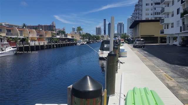 view of dock with a water view and a balcony