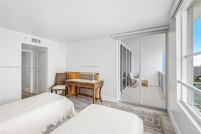 bedroom featuring light hardwood / wood-style floors and multiple windows