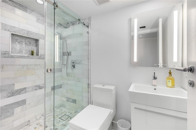 bathroom featuring vanity, toilet, and an enclosed shower