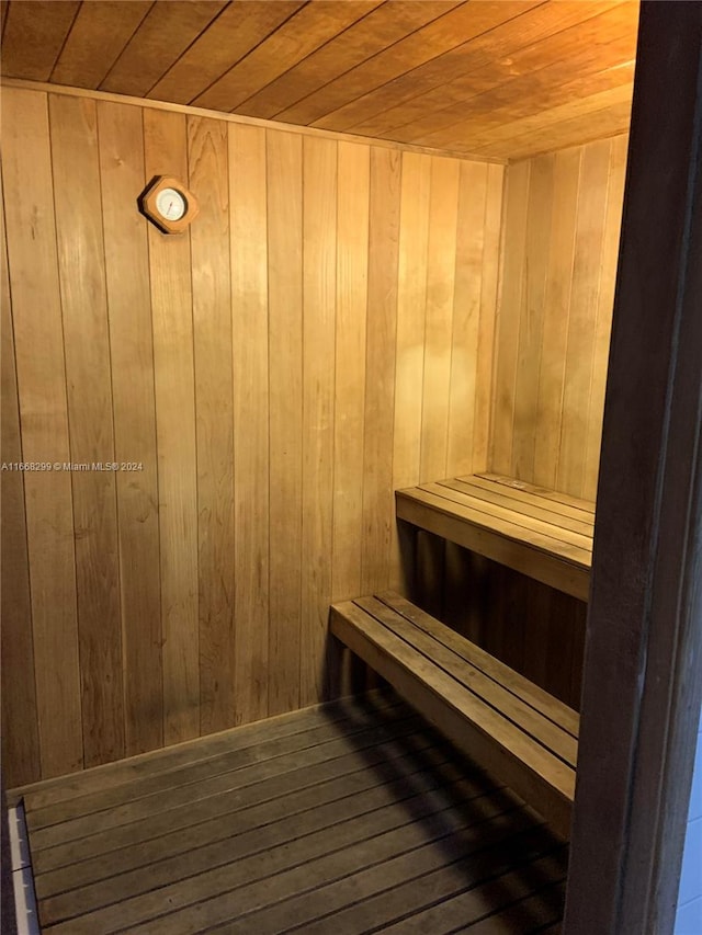 view of sauna featuring wood ceiling, wood-type flooring, and wood walls