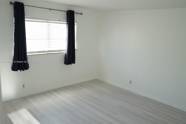 spare room featuring light hardwood / wood-style flooring