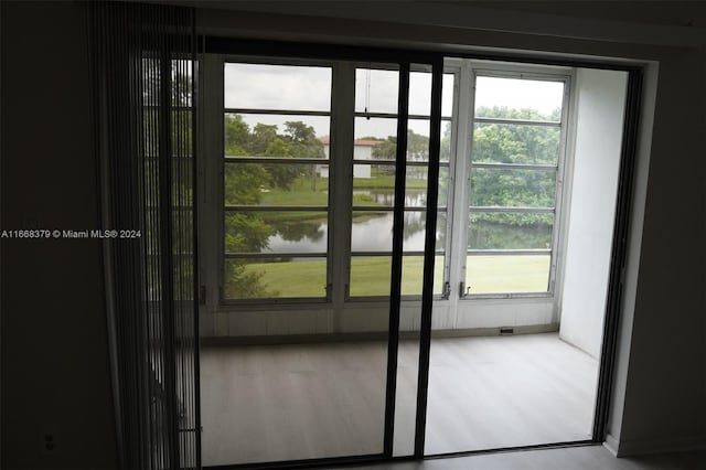 entryway featuring a water view and hardwood / wood-style flooring