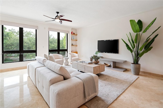 living room featuring ornamental molding, ceiling fan, and a textured ceiling