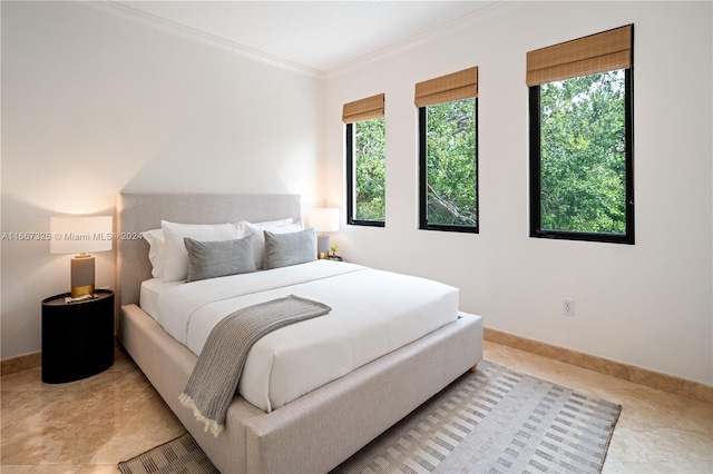 bedroom featuring crown molding and multiple windows