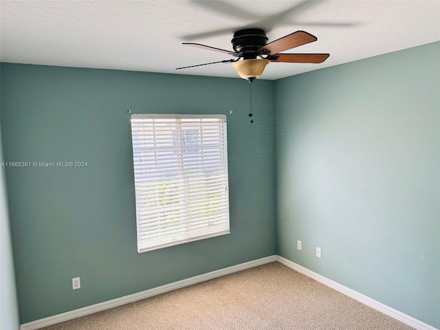 carpeted empty room featuring a textured ceiling and ceiling fan