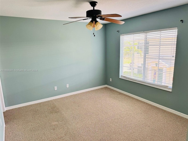 carpeted empty room featuring ceiling fan