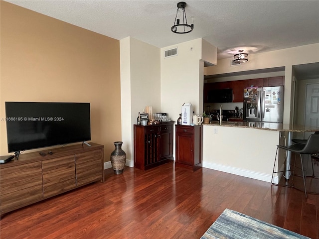 7275 SW 90th Way Unit 407, Miami, FL 33156 - living area with dark wood-style flooring, visible vents, baseboards, and a textured ceiling