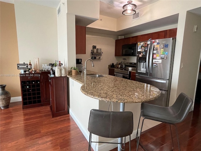 7275 SW 90th Way Unit 407, Miami, FL 33156 - kitchen with a sink, dark wood finished floors, a peninsula, and stainless steel appliances
