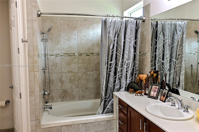 bathroom featuring tiled shower / bath combo and vanity