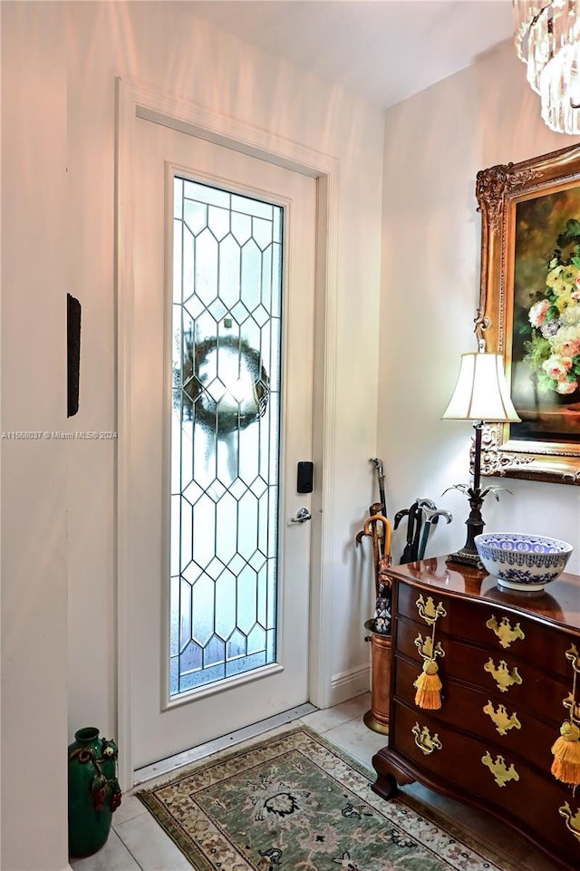 foyer entrance featuring light tile patterned floors and a wealth of natural light