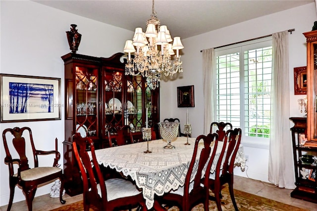 dining room with an inviting chandelier and tile patterned floors