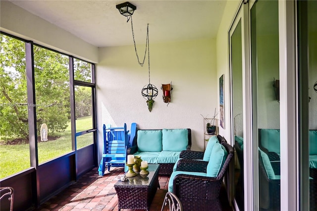 sunroom / solarium featuring outdoor lounge area