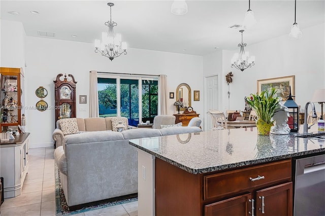 kitchen with a chandelier, stainless steel dishwasher, a sink, and light tile patterned floors