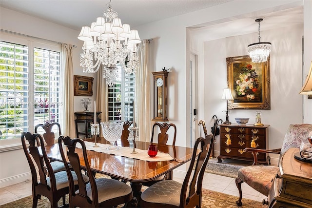 dining room with a chandelier, light tile patterned flooring, and plenty of natural light