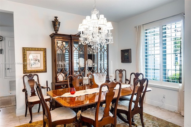 dining room featuring a chandelier, healthy amount of natural light, baseboards, and light tile patterned flooring