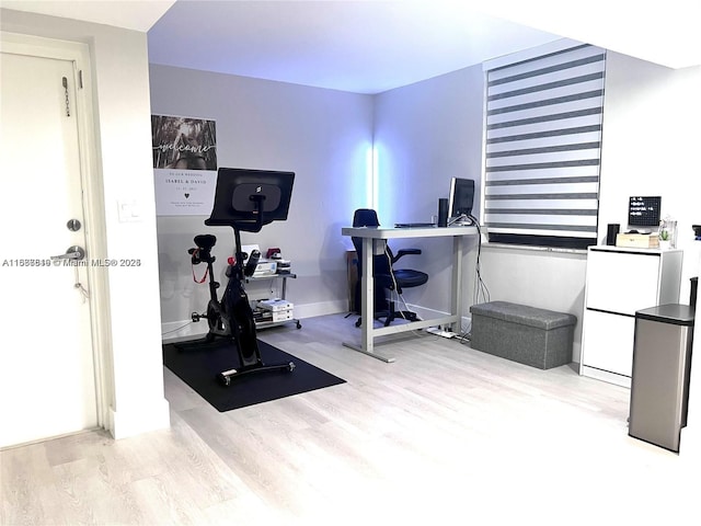 exercise area with light hardwood / wood-style flooring