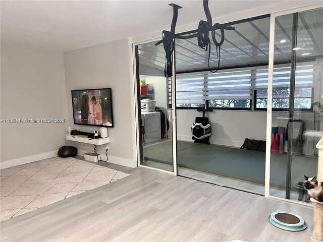 interior space with washer / clothes dryer, hardwood / wood-style floors, and a wealth of natural light