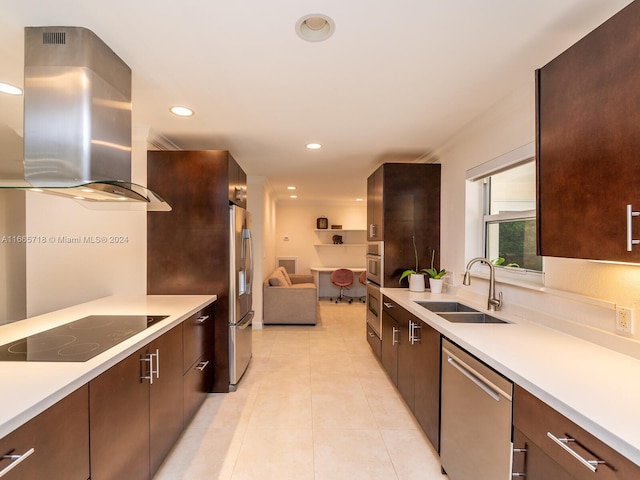 kitchen featuring stainless steel appliances, light tile patterned flooring, sink, dark brown cabinets, and wall chimney range hood